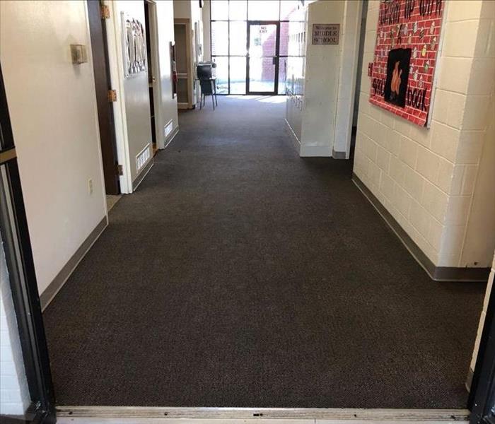 Wet carpet in a middle school hallway