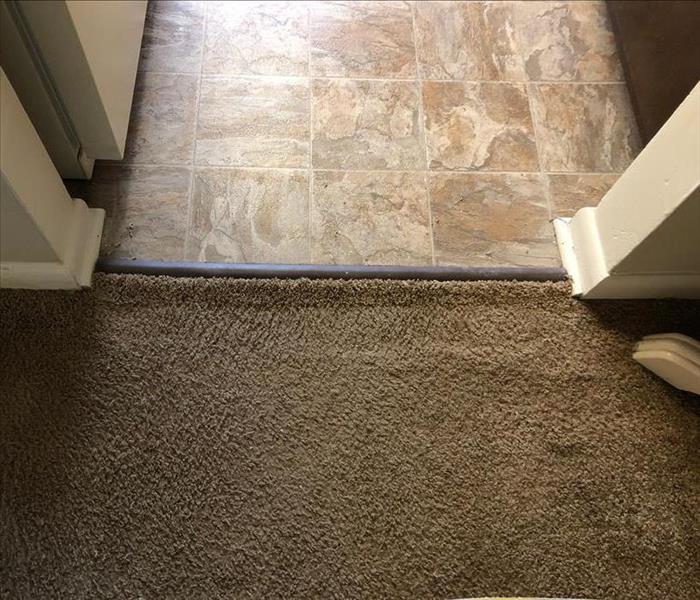 Carpet seam attached under transition strip