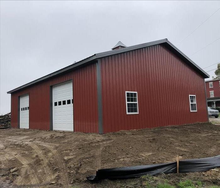 New big red barn with two garage doors