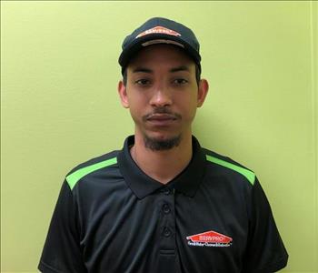Male employee in a black shirt and hat